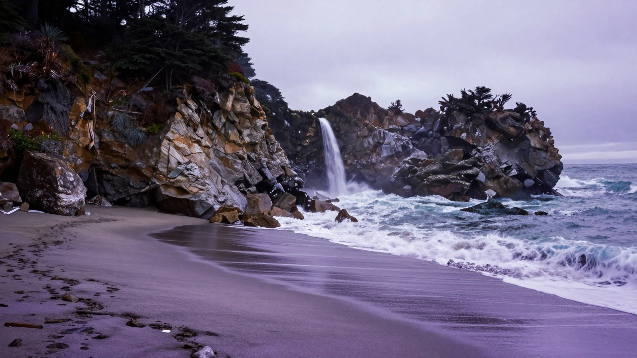 Big Sur&#039;s Pfeiffer Beach with purple sand, dramatic cliffs, and a waterfall falling onto rocks.