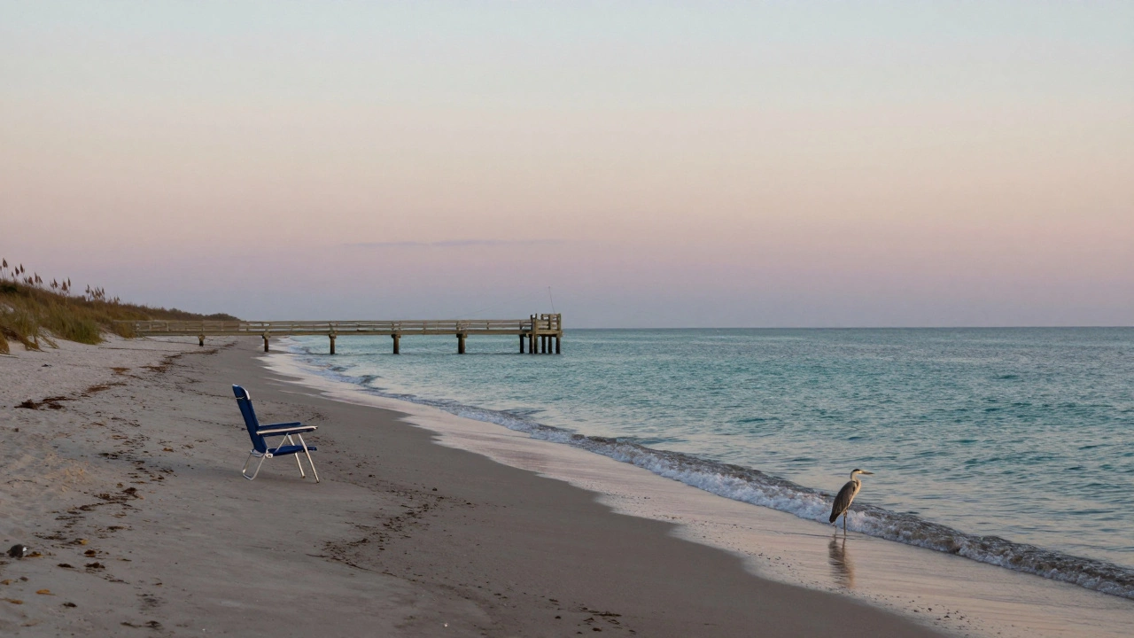 Peaceful Clearwater beach at dawn with empty chair and heron in tide pools